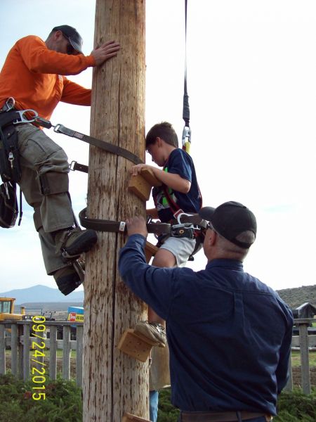 Kid climbing power pole at fair